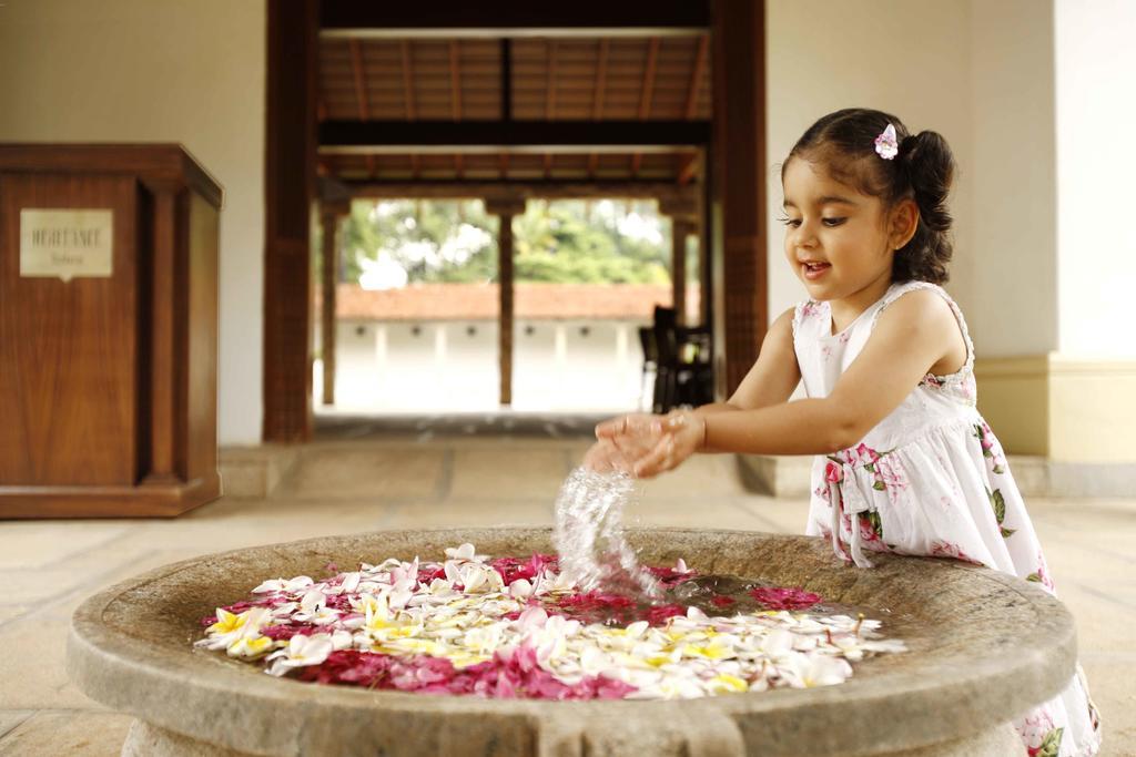 Heritage Madurai Eksteriør bilde A girl playing with flowers